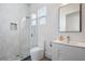 Modern bathroom with a glass shower, white vanity, and marble tile at 830 W Canton Ave, Winter Park, FL 32789