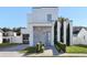 Modern two-story home with gray stone accents and landscaping at 830 W Canton Ave, Winter Park, FL 32789