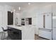 Modern kitchen with white cabinets, marble countertops, and stainless steel appliances at 830 W Canton Ave, Winter Park, FL 32789