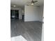 Bright living room with grey vinyl flooring and ceiling fan at 8429 Sw 105Th Pl, Ocala, FL 34481