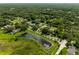 Aerial view of a residential area with houses, trees, and a pond at 858 Cardinal Pointe Cv, Sanford, FL 32771