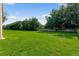 Large grassy backyard with mature trees and a wooden fence at 858 Cardinal Pointe Cv, Sanford, FL 32771