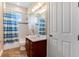 Clean bathroom with a tub shower, single vanity and striped shower curtain at 858 Cardinal Pointe Cv, Sanford, FL 32771