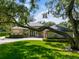 House exterior with large tree and manicured lawn at 858 Cardinal Pointe Cv, Sanford, FL 32771