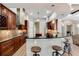 Modern kitchen with dark wood cabinets, granite countertops, and a breakfast bar at 858 Cardinal Pointe Cv, Sanford, FL 32771