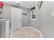 Convenient laundry room with white washer, dryer, and herringbone floors at 858 Cardinal Pointe Cv, Sanford, FL 32771