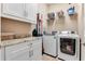 Bright laundry room with washer, dryer, and cabinets at 858 Cardinal Pointe Cv, Sanford, FL 32771