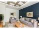 Living room with dark blue accent wall and two armchairs at 913 Carlson Dr, Orlando, FL 32804