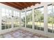 Bright sunroom with tiled floor and view of backyard at 913 Carlson Dr, Orlando, FL 32804