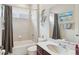 Clean bathroom provides a tub with shower, a toilet, and a single sink vanity with decorative mirror at 9132 Via Bella Notte, Orlando, FL 32836