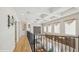 Upstairs hallway with wood floors, decorative ceiling, chandelier, and an iron railing at 9132 Via Bella Notte, Orlando, FL 32836