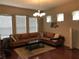 Living room with a large sectional sofa, hardwood floors, and ample light at 9132 Via Bella Notte, Orlando, FL 32836