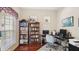 Well-lit home office featuring built-in bookcases, hardwood floors and neutral paint at 9132 Via Bella Notte, Orlando, FL 32836