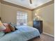 Bright bedroom with double bed and window access at 9451 Brownwood Ct, Oviedo, FL 32765