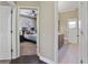 Hallway view of bedroom and bathroom with dark wood floors at 9451 Brownwood Ct, Oviedo, FL 32765