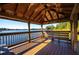 Covered wooden deck overlooking a serene lake at 9451 Brownwood Ct, Oviedo, FL 32765