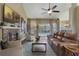 Bright living room featuring a fireplace, hardwood floors and sliding glass doors at 9451 Brownwood Ct, Oviedo, FL 32765