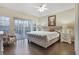 Large main bedroom with plush carpet and access to a private balcony at 9451 Brownwood Ct, Oviedo, FL 32765