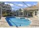 Inviting pool area with screened enclosure, patio, and lush landscaping at 9451 Brownwood Ct, Oviedo, FL 32765