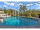 Enjoy this refreshing pool with screened enclosure and views at 9451 Brownwood Ct, Oviedo, FL 32765