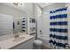 Clean bathroom with a bathtub, shower, and nautical-themed decor at 9511 Nautique Ln, Winter Garden, FL 34787