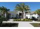 Community clubhouse with palm trees and landscaping at 9511 Nautique Ln, Winter Garden, FL 34787