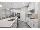 Modern kitchen with white cabinets, large island, and stainless steel appliances at 9511 Nautique Ln, Winter Garden, FL 34787