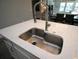 Modern kitchen sink with stainless steel basin and quartz countertop at 9511 Nautique Ln, Winter Garden, FL 34787