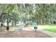 Community playground nestled under shady oak trees near a lake at 9511 Nautique Ln, Winter Garden, FL 34787