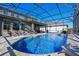 Luxury pool with screened enclosure and lounge chairs at 9511 Nautique Ln, Winter Garden, FL 34787