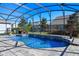 Relaxing kidney-shaped pool with a screened enclosure and water features at 9511 Nautique Ln, Winter Garden, FL 34787