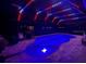 Stunning pool at night with colorful LED lights at 9511 Nautique Ln, Winter Garden, FL 34787