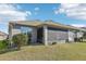 A view of the home's backyard with screen enclosed porch area and well-maintained lawn at 1040 Sadie Ridge Rd, Clermont, FL 34715