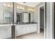 Bathroom with double vanity, granite countertop and large mirror at 1040 Sadie Ridge Rd, Clermont, FL 34715