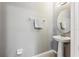 Small pedestal sink bathroom with round mirror at 1040 Sadie Ridge Rd, Clermont, FL 34715