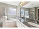 Double sink bathroom with granite countertop and soaking tub at 1040 Sadie Ridge Rd, Clermont, FL 34715