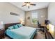 Bright bedroom with a queen bed, workspace, and large window at 1040 Sadie Ridge Rd, Clermont, FL 34715