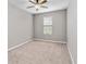 Cozy bedroom with neutral paint, plush carpet, a ceiling fan, and a window providing natural light at 1040 Sadie Ridge Rd, Clermont, FL 34715