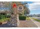 Stone-based community sign decorated with greenery and a decorative red ribbon for a warm welcome at 1040 Sadie Ridge Rd, Clermont, FL 34715