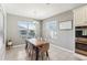 Bright dining area with wood table and gray chairs, features tile floor and window blinds at 1040 Sadie Ridge Rd, Clermont, FL 34715