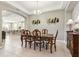 Elegant dining room with dark wood table and kitchen view at 1040 Sadie Ridge Rd, Clermont, FL 34715