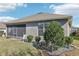 House exterior showcasing a screened porch and landscaped yard at 1040 Sadie Ridge Rd, Clermont, FL 34715