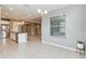 Bright kitchen and dining area featuring stainless steel appliances, tile flooring, pendant lighting, and open layout at 1040 Sadie Ridge Rd, Clermont, FL 34715