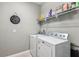 Laundry room with washer, dryer, and shelving at 1040 Sadie Ridge Rd, Clermont, FL 34715