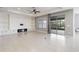 Bright living room features a fireplace with built-in shelving and access to the lanai at 1040 Sadie Ridge Rd, Clermont, FL 34715