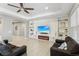 Living room with built-in shelves, fireplace, and large TV at 1040 Sadie Ridge Rd, Clermont, FL 34715