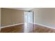 Bright bedroom featuring hardwood floors and an open doorway at 106 Canterbury Dr, Haines City, FL 33844