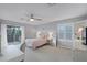 Main bedroom with private balcony access and a ceiling fan at 1105 Harbor Hill St, Winter Garden, FL 34787