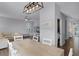 Bright dining room with light wood table and view into kitchen and living room at 1105 Harbor Hill St, Winter Garden, FL 34787