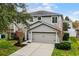 Two-story house with gray siding, attached garage, and well-manicured lawn at 1105 Harbor Hill St, Winter Garden, FL 34787